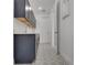 Stylish laundry room with patterned tile floor and gray cabinets at 14249 Crest Palm Ave, Windermere, FL 34786
