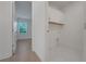 Spacious laundry room with tiled floor, cabinets, and adjacent hallway at 14249 Crest Palm Ave, Windermere, FL 34786