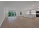Open-concept living room connected to a modern eat-in kitchen with a glass sliding door at 14249 Crest Palm Ave, Windermere, FL 34786