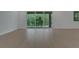 Light-filled living room with wood-look floors and sliding glass doors at 14249 Crest Palm Ave, Windermere, FL 34786