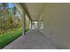 Covered patio with brick pavers and views of the lush backyard and landscaping at 14249 Crest Palm Ave, Windermere, FL 34786