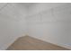 Spacious walk-in closet with wire shelving and wood-look flooring, perfect for organization at 14249 Crest Palm Ave, Windermere, FL 34786