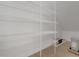 Walk-in closet with floor-to-ceiling white wire shelving providing lots of storage space at 14249 Crest Palm Ave, Windermere, FL 34786