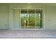 A covered patio with brick pavers and a sliding glass door offers outdoor living space at 14261 Crest Palm Ave, Windermere, FL 34786