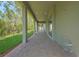 A long covered patio with brick pavers offers an inviting outdoor space with views of the backyard at 14261 Crest Palm Ave, Windermere, FL 34786
