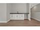 A simple bar area features bright white cabinets, dark hardware and a dark countertop, offering a blank canvas at 14261 Crest Palm Ave, Windermere, FL 34786