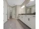 Large bathroom featuring gray tile floors, double vanity and two doors to other rooms at 14261 Crest Palm Ave, Windermere, FL 34786