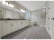 Bright bathroom featuring a double vanity, freestanding tub and glass shower at 14261 Crest Palm Ave, Windermere, FL 34786