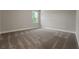 Neutral bedroom with light grey walls, neutral carpet, white trim, and large window at 14261 Crest Palm Ave, Windermere, FL 34786