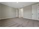 Spacious bedroom with neutral carpet, light gray walls, and multiple doorways and closets at 14261 Crest Palm Ave, Windermere, FL 34786