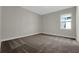 Neutral bedroom with gray walls, plush carpet, and a window offering natural light at 14261 Crest Palm Ave, Windermere, FL 34786