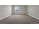 Neutral bedroom with plush carpet and a bright window, providing a clean and airy feel at 14261 Crest Palm Ave, Windermere, FL 34786