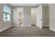 Bedroom with a carpeted floor, ensuite bathroom, closet, and a bright window at 14261 Crest Palm Ave, Windermere, FL 34786