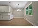 Bright dining area with stylish lighting, built-in cabinets, and a large window with a view at 14261 Crest Palm Ave, Windermere, FL 34786