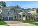 Charming two-story home featuring a brick driveway, two car garage, and beautifully landscaped front yard at 14261 Crest Palm Ave, Windermere, FL 34786