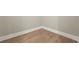 Corner of a room showing light wood-look flooring with white baseboards and light gray walls at 14261 Crest Palm Ave, Windermere, FL 34786