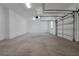 Spacious two-car garage featuring concrete flooring, a modern garage door, and bright lighting at 14261 Crest Palm Ave, Windermere, FL 34786