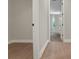 Hallway features light wood-look floors and leads to a bedroom with neutral carpet and natural light at 14261 Crest Palm Ave, Windermere, FL 34786
