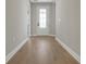 Hallway features a glass front door with wood-look floors and neutral walls at 14261 Crest Palm Ave, Windermere, FL 34786