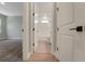 Hallway view into an adjacent bathroom with tile floors and shower at 14261 Crest Palm Ave, Windermere, FL 34786