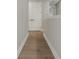 Neutral hallway with hardwood floors, white trim, and doors with black hardware at 14261 Crest Palm Ave, Windermere, FL 34786