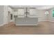 Bright, white kitchen features an island with stainless steel appliances and ample cabinet space at 14261 Crest Palm Ave, Windermere, FL 34786