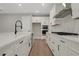 A well-designed kitchen showcasing white cabinets, stainless steel appliances, and modern fixtures at 14261 Crest Palm Ave, Windermere, FL 34786