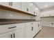 Elegant laundry room with white cabinets, dark hardware, countertops, sink, and tile flooring at 14261 Crest Palm Ave, Windermere, FL 34786
