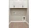 A practical laundry area with upper cabinets, tile floors, and convenient utility hookups at 14261 Crest Palm Ave, Windermere, FL 34786