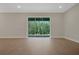 Spacious living room with hardwood floors and sliding glass doors with a backyard view at 14261 Crest Palm Ave, Windermere, FL 34786