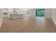 Bright living room featuring wood floors and natural light from the sliding glass door at 14261 Crest Palm Ave, Windermere, FL 34786