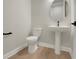 Half bathroom features a pedestal sink and modern fixtures at 14261 Crest Palm Ave, Windermere, FL 34786