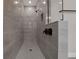 Contemporary walk-in shower with gray tiles, sleek fixtures, and a convenient niche at 14261 Crest Palm Ave, Windermere, FL 34786