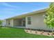 Backyard view featuring a covered patio, lush lawn, and a landscaped border at 14285 Crest Palm Ave, Windermere, FL 34786