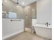 Modern bathroom featuring a glass-enclosed shower and a soaking tub at 14285 Crest Palm Ave, Windermere, FL 34786