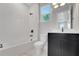 Modern bathroom featuring a shower and tub combo, black fixtures, and a marble floor at 14285 Crest Palm Ave, Windermere, FL 34786