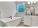 Relaxing bathroom with modern tub and vanity, complemented by sleek fixtures at 14285 Crest Palm Ave, Windermere, FL 34786
