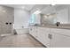 Bright bathroom featuring double vanities, sleek fixtures, and a modern tub at 14285 Crest Palm Ave, Windermere, FL 34786