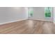 Large bedroom featuring wood-look floors and bright windows at 14285 Crest Palm Ave, Windermere, FL 34786
