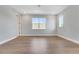 A bright bedroom featuring hardwood floors and two windows letting in natural light at 14285 Crest Palm Ave, Windermere, FL 34786
