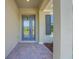 Welcoming front porch with gray stucco siding and a blue front door at 14285 Crest Palm Ave, Windermere, FL 34786