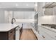 Well-lit kitchen features a black island, modern appliances, and bright white cabinetry at 14285 Crest Palm Ave, Windermere, FL 34786