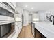 Modern kitchen boasts a large island, modern appliances, and sleek white cabinetry at 14285 Crest Palm Ave, Windermere, FL 34786