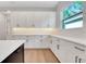 Beautiful kitchen features a black island, modern appliances, and bright white cabinetry at 14285 Crest Palm Ave, Windermere, FL 34786
