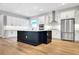 Spacious kitchen with white cabinets, a black island, and stainless-steel appliances at 14285 Crest Palm Ave, Windermere, FL 34786