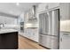 Modern kitchen boasts stainless appliances, white cabinetry, and a stainless range hood at 14285 Crest Palm Ave, Windermere, FL 34786