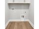 Modern laundry room features overhead storage at 14285 Crest Palm Ave, Windermere, FL 34786