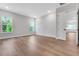 Open-concept living area with two windows, light grey paint and wood-look floors at 14285 Crest Palm Ave, Windermere, FL 34786