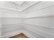 Spacious pantry features a ventilated metal shelving system for convenient storage at 14285 Crest Palm Ave, Windermere, FL 34786