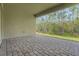 Spacious covered patio with brick flooring surrounded by lush landscaping at 14285 Crest Palm Ave, Windermere, FL 34786